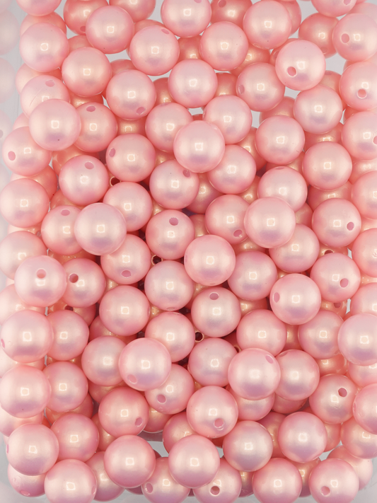 Collection of light pink colored beads with a pearl shimmer finish