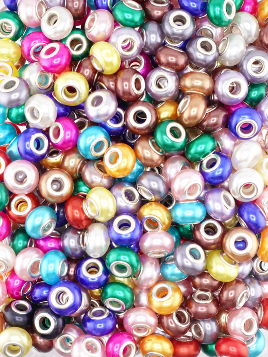 Collection of pearl spacers in a variety of colors like red, yellow, blue, green and purple.