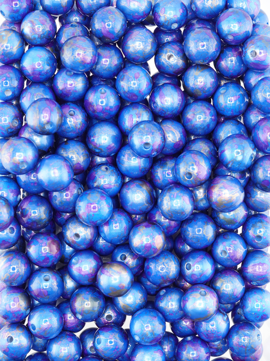 Collection of blue beads with a pearl finish and paint splatter design