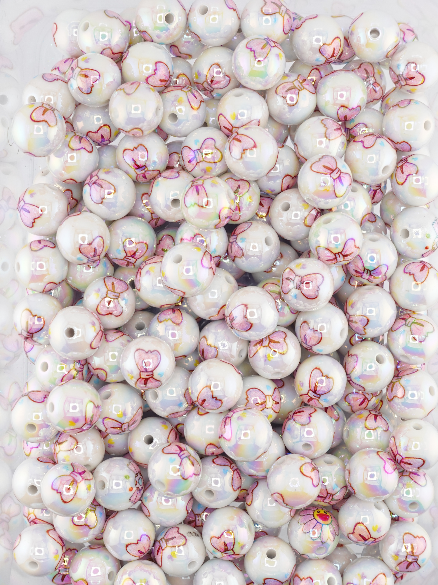 Collection of beads with a pink bow print design