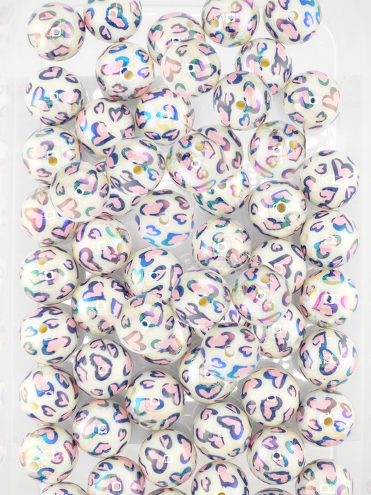 Collection of white beads featuring a pink heart design