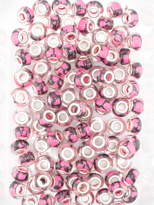 Collection of black spacers with a pink heart design