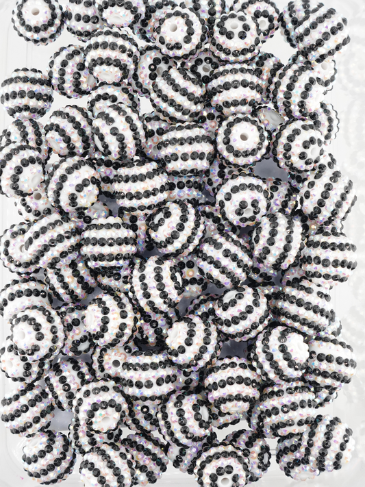 Collection of black and white beads with aurora borealis finish and stripe design