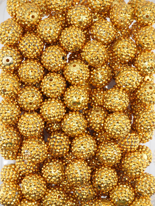 Collection of gold beads with rhinestone texture