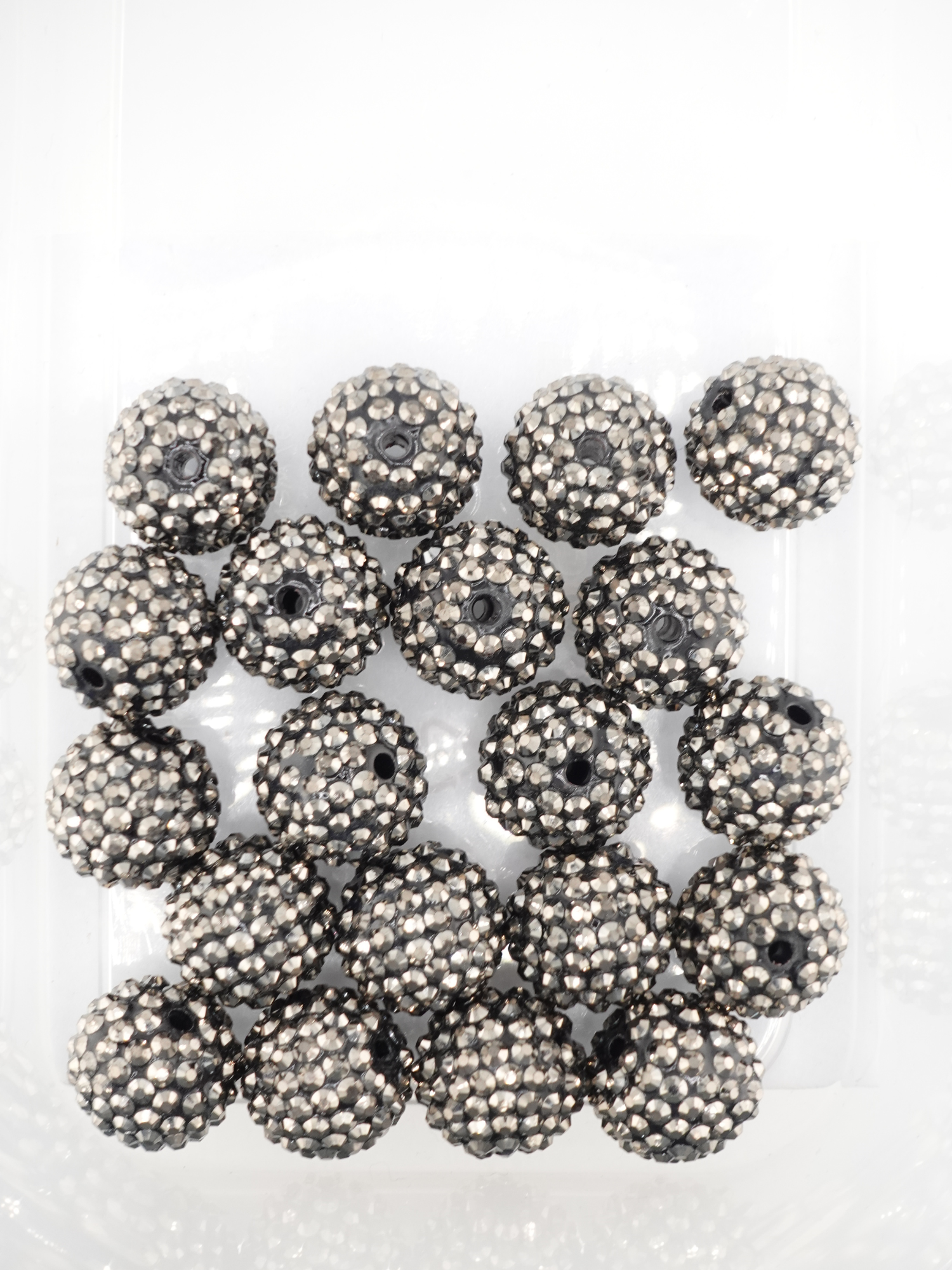 Collection of silver colored beads with rhinestone texture