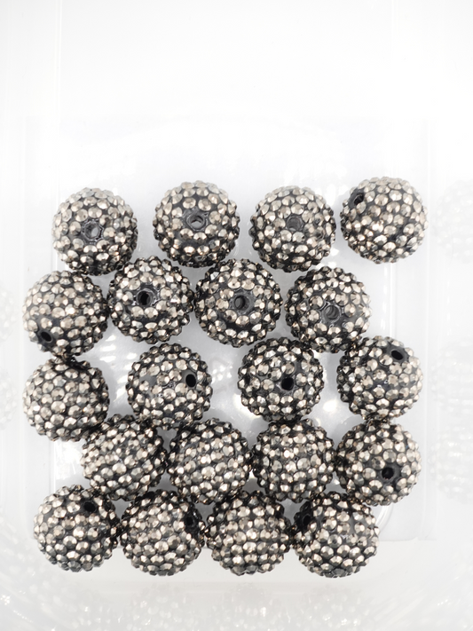 Collection of silver colored beads with rhinestone texture