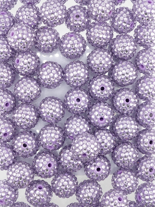 Collection of lilac colored beads with rhinestone texture