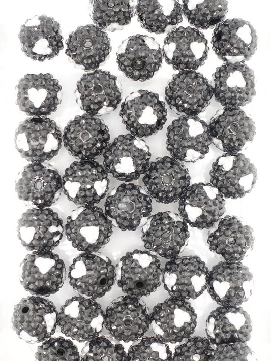 Collection of black colored beads with white hearts