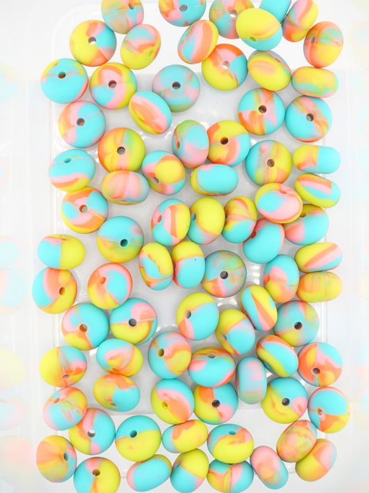 Collection of rainbow colored silicone spacers with a swirl pattern