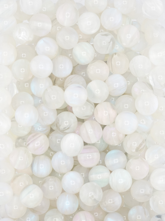 Collection of volcano beads in the colors white, light pink, and light blue. Pastel colors